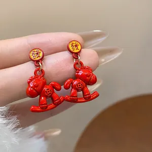 Detailed macro view of red enamel rocking horse earrings with Chinese Fa character stud