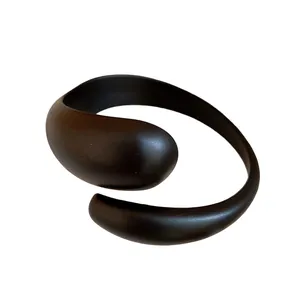 Minimalist matte black acrylic open cuff bracelet with a smooth contemporary circular design