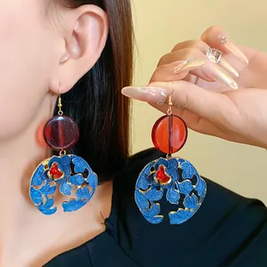 Detailed view of New Chinese style resin flower and leaf dangle earrings worn on the ear.