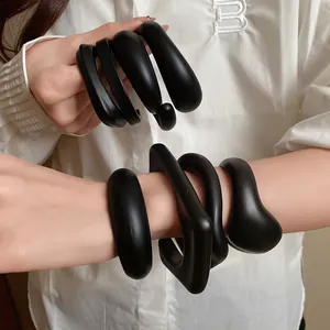 Chunky matte black acrylic open cuff bracelets with irregular organic shapes