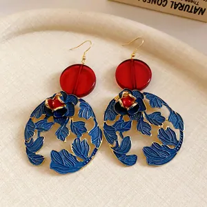 Close-up of new Chinese style resin flower and leaf dangle earrings in blue and red