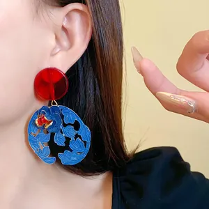 Close-up of vibrant blue and red floral cutout drop earrings in neo-Chinese style