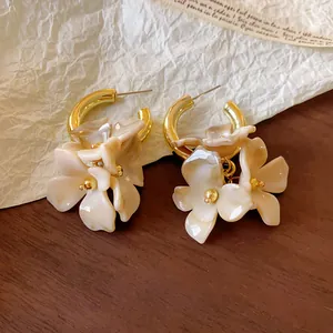 Detailed shot of vintage acrylic flower hoop earrings with marble effect finish.