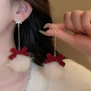 Elegant snowflake earrings with red velvet bow and white fluffy pom-pom dangles