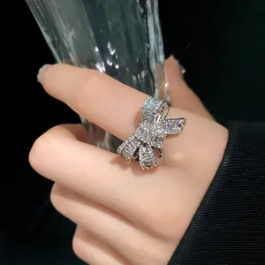 Exquisite silver-colored bow-shaped open ring with sparkling zircon pavé setting on finger