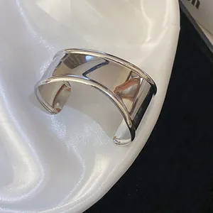 Close-up of a stylish silver irregular geometric cuff bracelet with a polished finish