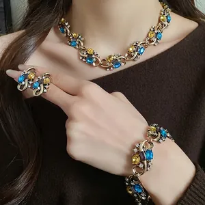 Vintage royal style jewelry set with blue and yellow rhinestones in a golden antique finish