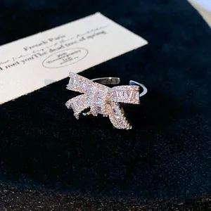 Close-up of elegant silver bow ring with sparkling cubic zirconia in open design