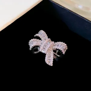 Detailed macro view of a silver bow ring encrusted with sparkling white zircons