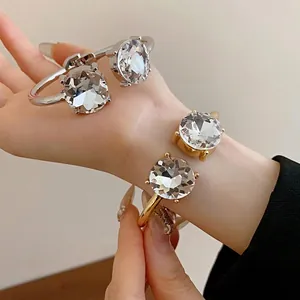 Elegant open bangle bracelets with large round crystals in gold and silver finish