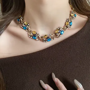 Detailed view of a vintage court-style necklace with colorful rhinestone settings.
