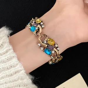 Close-up of vintage court style bracelet with colorful oval rhinestones on wrist