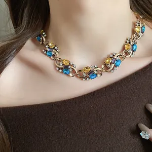 Vintage style choker necklace with colorful oval stones worn by a model