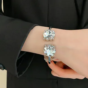 Detail view of a luxurious sparkling round crystal open cuff bracelet worn on the wrist