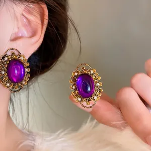 French vintage purple oval clip-on earrings with pearl accents on an Asian model