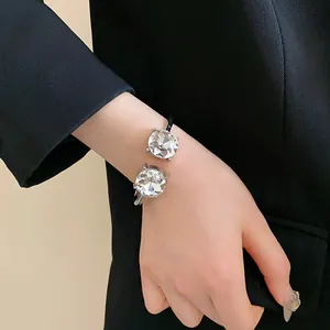 Exquisite silver-tone open cuff bracelet featuring two large round-cut sparkling crystals.