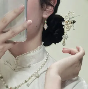 Model wearing elegant floral hair stick with tassels and matching jewelry in Chinese style