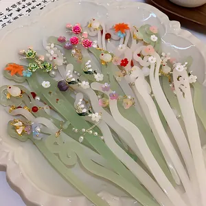 Close-up view of traditional Chinese style floral hairpins with jade-like texture and pearls