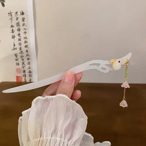 Close-up of elegant Chinese style hair stick with rabbit motif and delicate flower tassels