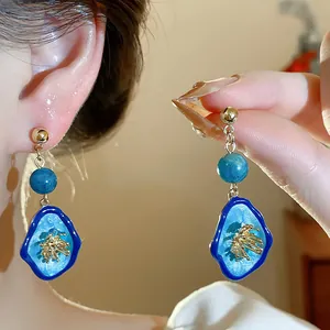 Detailed view of New Chinese style blue stone flower drop earrings with gold finish