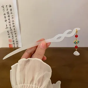 Close-up detail of white resin hair stick with tassel for elegant Hanfu styling
