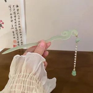 Close-up of a light green New Chinese style hair stick featuring a pearl tassel and gourd pendant.