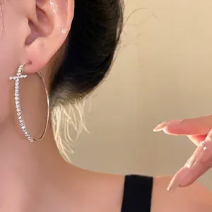 Elegant luxury silver-toned large hoop earrings featuring a rhinestone cross motif for women