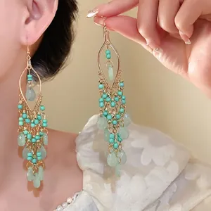 Bohemian turquoise bead drop earrings with acrylic stones shown on model