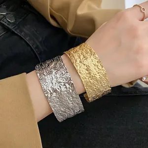 Fashionable chunky hammered metal open cuff bangle in gold and silver tones for women
