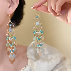 Close-up of Bohemian teardrop earrings with colorful acrylic beads and gold frame