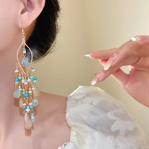 Detailed view of Bohemian ethnic long earrings with colorful beads and teardrop pendants