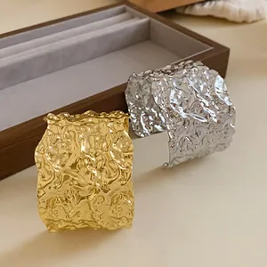 Detailed view of elegant hammered metal cuff bracelets in shiny gold and silver finish