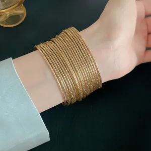 Elegante set van meerdere gouden getextureerde armbanden detailweergave om pols
