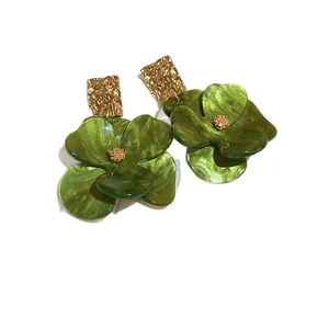 Handcrafted elegant green flower earrings made of acrylic and gold-toned textured metal.