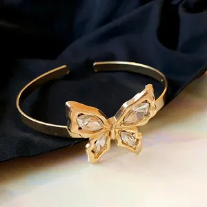 Detailed view of a gold-colored butterfly cuff bracelet with sparkling marquise crystals