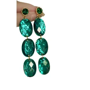 Vintage emerald green acrylic drop earrings featuring geometric oval textured dangles.