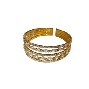 Multi-layer gold open bangle decorated with rows of white pearls and sparkling rhinestones