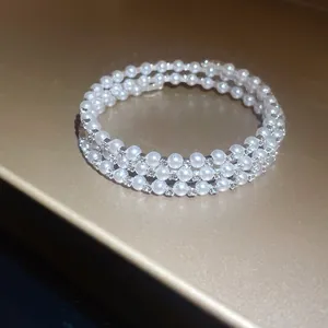 Close-up of elegant multi-layer pearl bracelet with sparkling rhinestone details