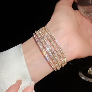 Close-up of sparkling rhinestone and pearl multi-layer bracelet on female wrist