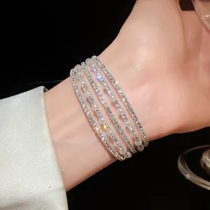 Detail shot of elegant multi-layer bracelet featuring sparkling crystals and white pearls