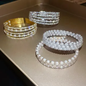 Macro view of multi-layer open bracelet with sparkling rhinestones and white pearls