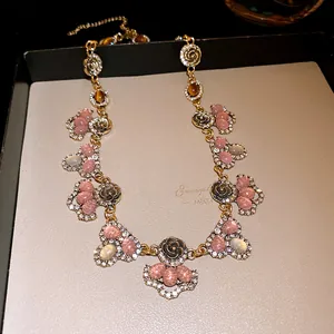 Close-up detail of a vintage resin and rhinestone floral statement collar necklace