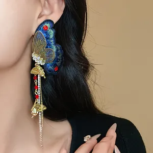 Close-up detail of luxury ethnic style butterfly tassel earring with sparkling rhinestones