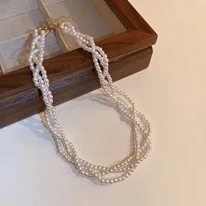 Elegant multi-strand twisted pearl necklace with vintage gold clasp and adjustable chain