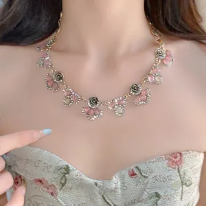 Detailed view of a vintage floral necklace with pink resin stones and rhinestones