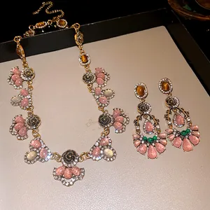 Macro detail view of luxury vintage resin floral necklace and matching earrings set