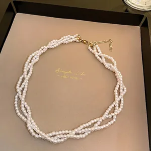 Luxurious multi-strand white pearl necklace featuring a retro gold-tone clasp and chain.