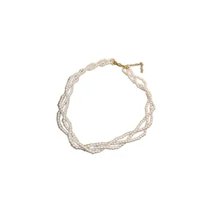 Elegant multi-strand baroque style white pearl necklace with gold lobster clasp on white background