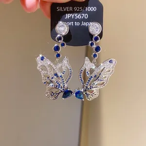 Elegant butterfly stud earrings with blue waterdrop zircons and silver needle detail