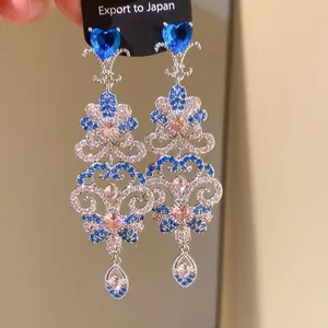 Elegant silver dangle earrings featuring blue heart zircons and intricate tassel design